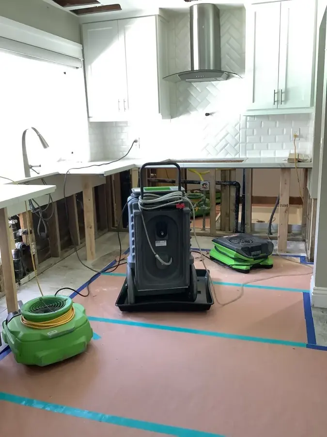 Air movers drying a South LA kitchen floor after a burst supply line